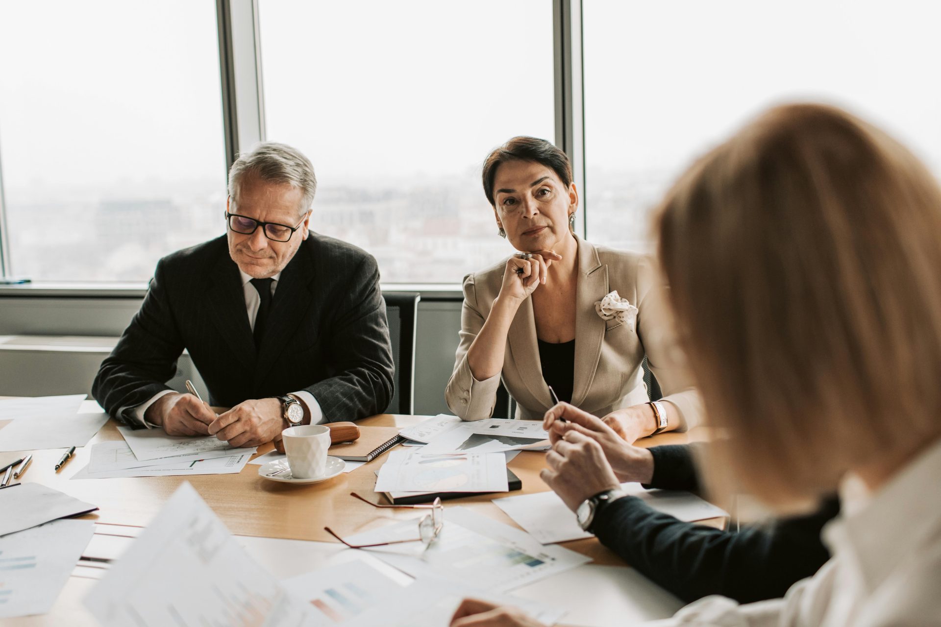 Business professionals in discussion during a meeting in a modern office setting.